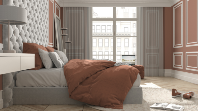 a bright bedroom with a mattress and bed sheet